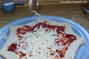 I swear this is the cutest Homemade Halloween Spiderweb Pizza. I can't wait to make this kid recipe with my son later he loves homemade pizza Halloween food
