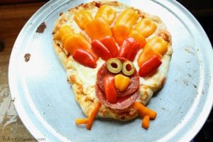 Sick of Thanksgiving food but still want something festive? Try this DIY Turkey Pizza for your kids. #Thanksgiving #kidfood #holidayfun #pizza #homemadeizza